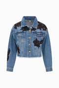 Cropped denim jacket with black lace appliqué, button front, and long sleeves