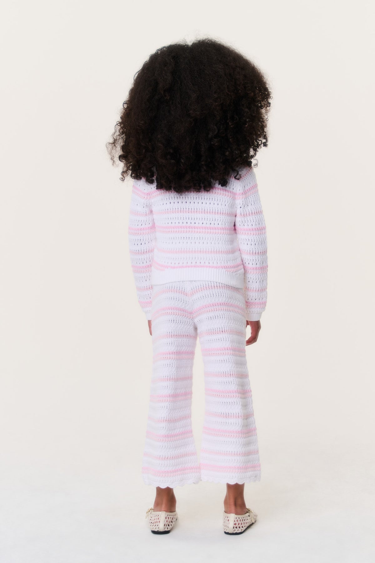 Girls crochet cardigan, back view, pink-and-white striped knit with long sleeves.