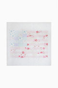 Light patchwork quilt with scattered pink and blue floral print, close-up