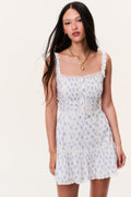 Light blue printed mini dress with square neckline, smocked bodice, lace-trim straps.