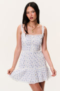 Light blue printed mini dress with square neckline, sleeveless lace trim, tiered skirt.