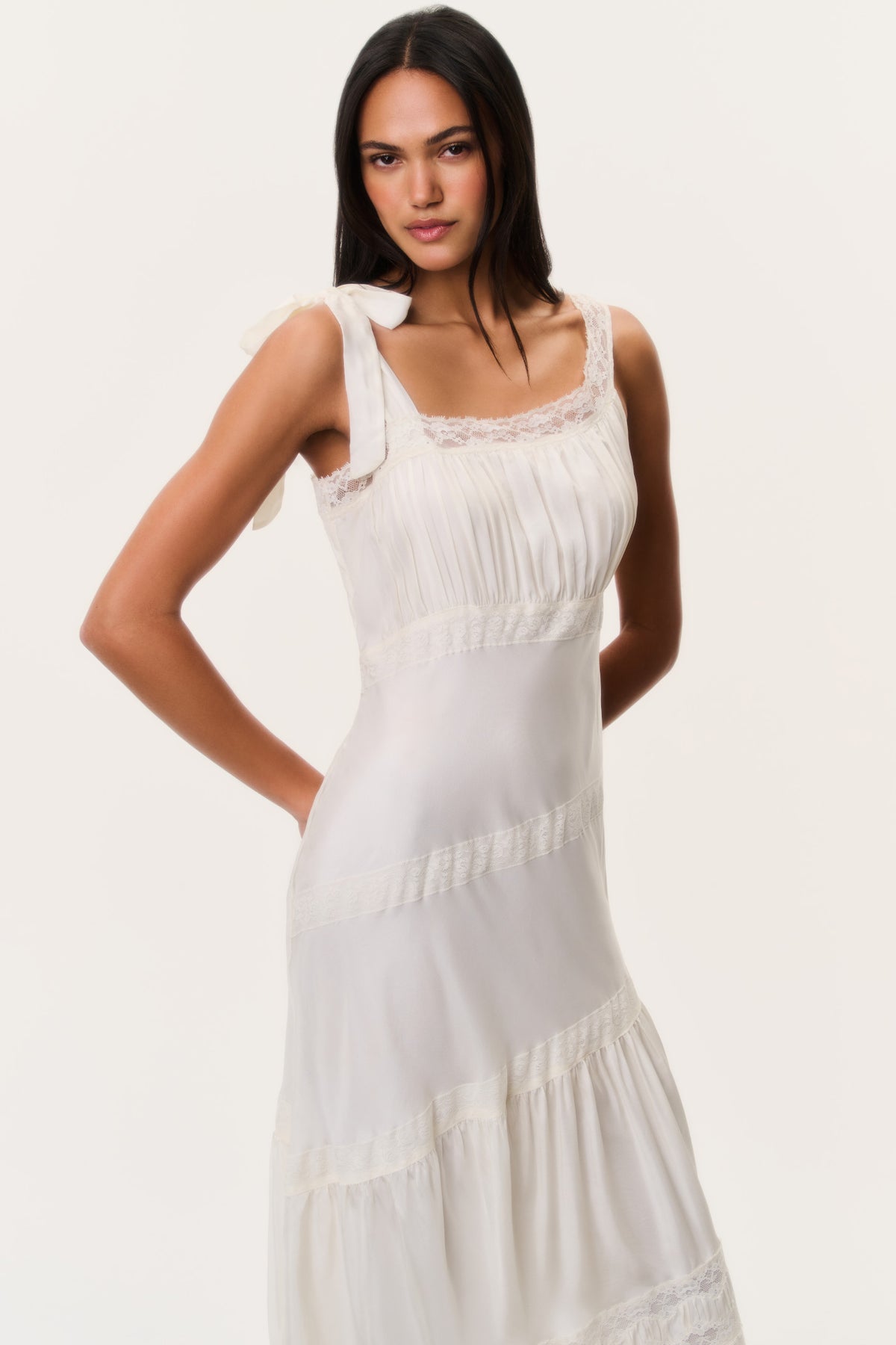 Ivory maxi dress with lace-trimmed square neckline, gathered bodice, and tiered skirt