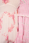 Upcycled cotton midi dress close-up: pink floral panels, ruffle tiers and striped texture