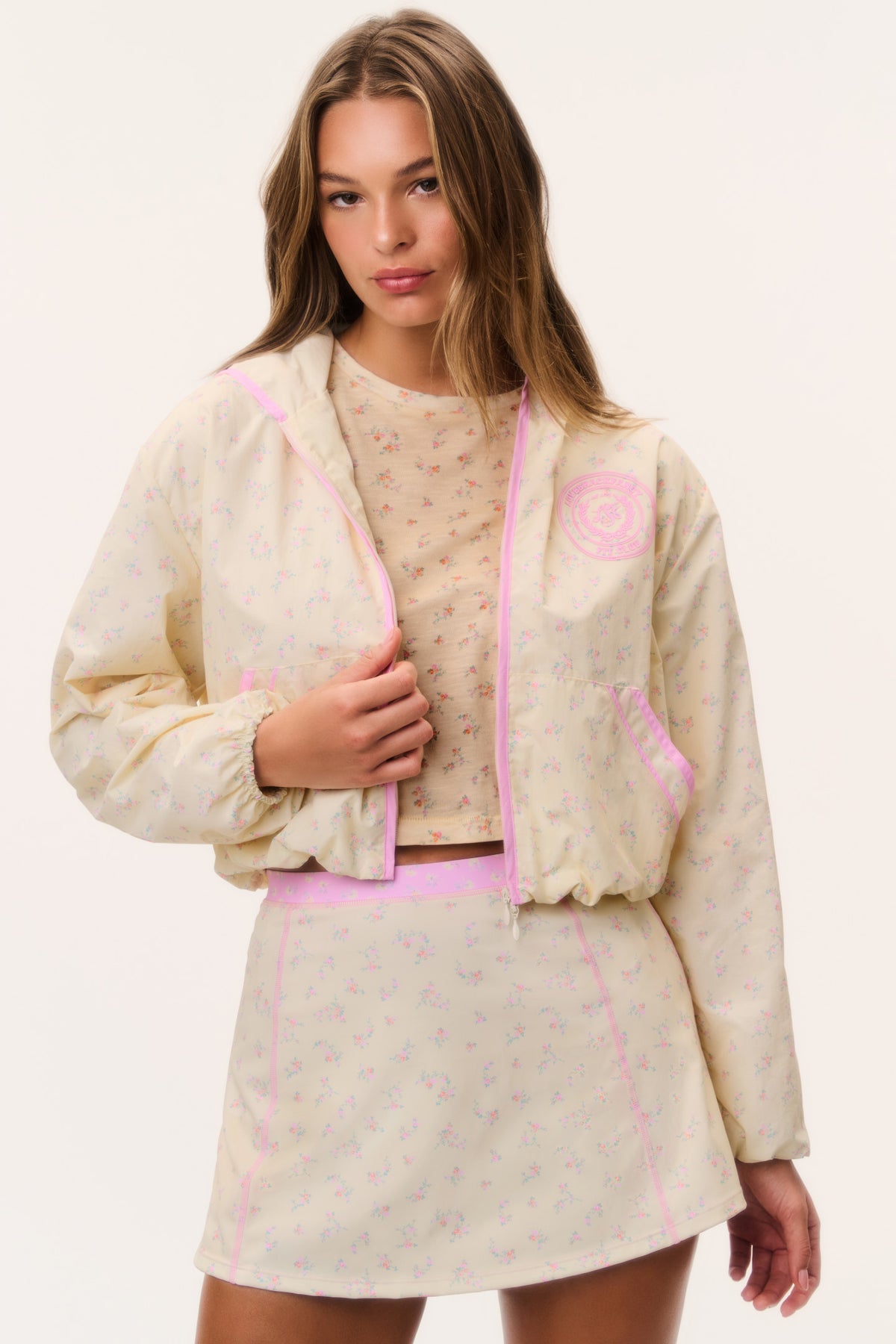 Cream windbreaker hoodie with pink zipper and hood, front view