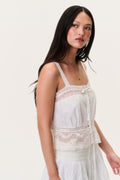 Ivory cotton lace camisole top with thin straps and layered peplum hem