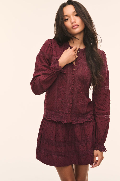 Burgundy Swiss dot blouse with button front, long puff sleeves, scalloped lace cuffs