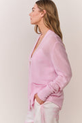 Pink cashmere cardigan with button front, patch pockets, and long sleeves