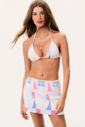 Patchwork print swim skirt in white, blue, and pink with flared ruffle hem