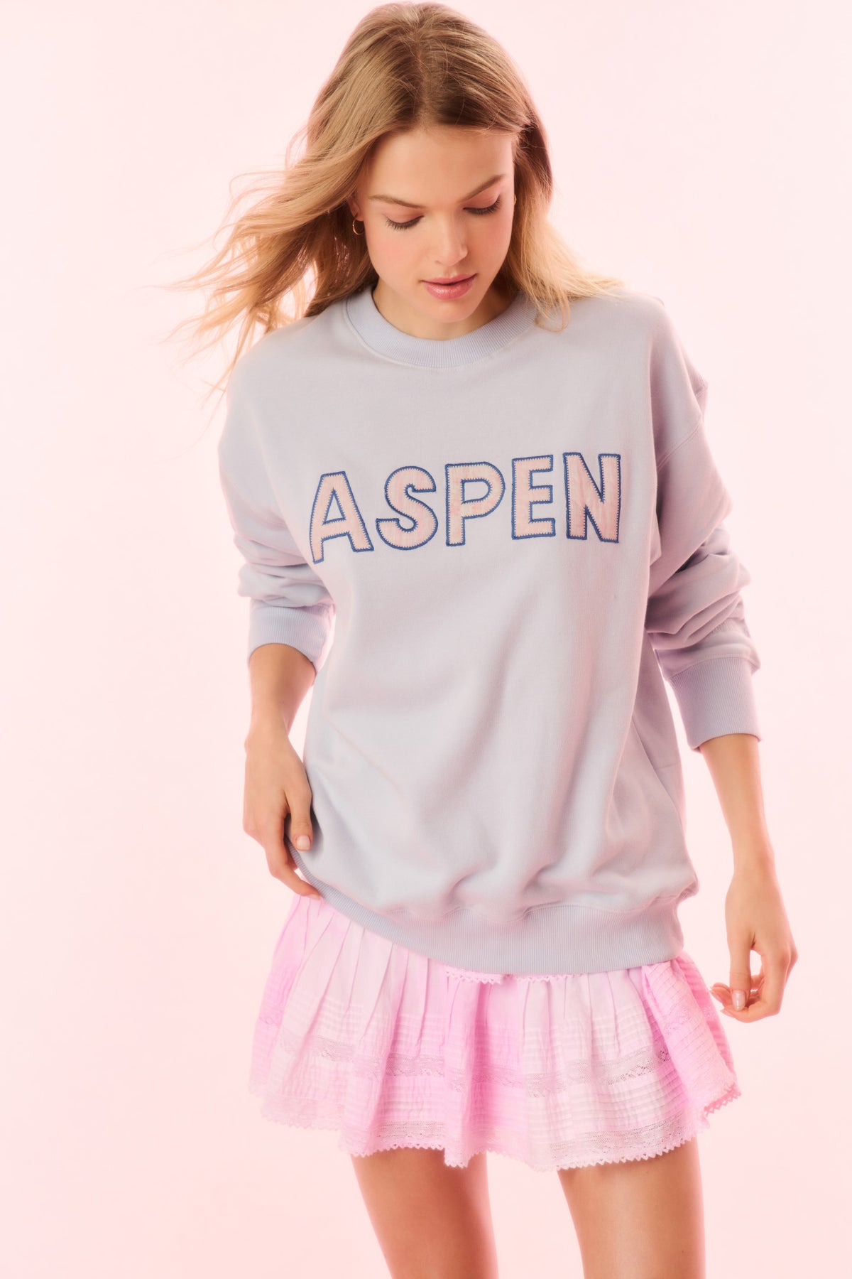 Light blue crewneck pullover sweatshirt with “ASPEN” logo graphic on front