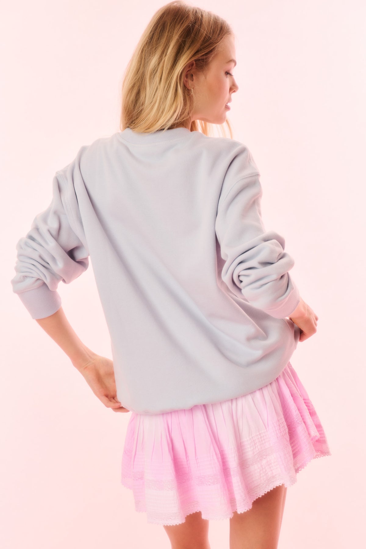 Light blue crewneck pullover sweatshirt with plain back and tiered hem finish