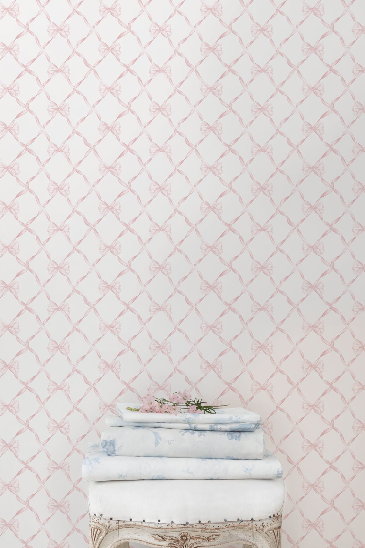 Bow-pattern wallpaper in faded primrose, showing pale bow lattice design