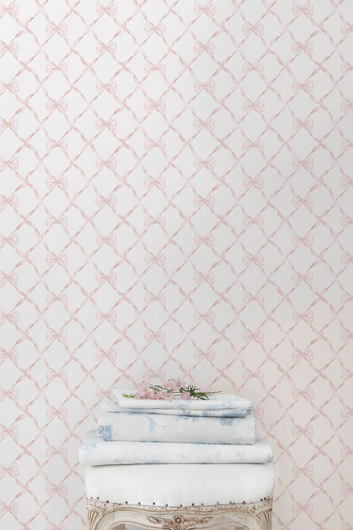 Bow-pattern wallpaper in faded primrose, showing pale bow lattice design