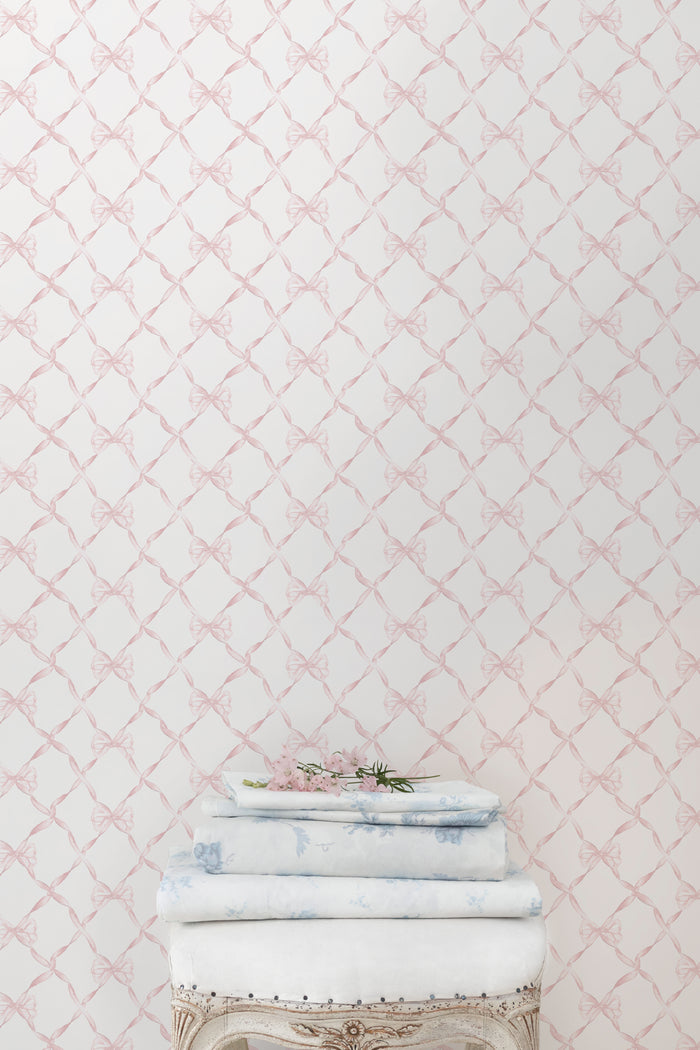 Bow-pattern wallpaper in faded primrose, showing pale bow lattice design