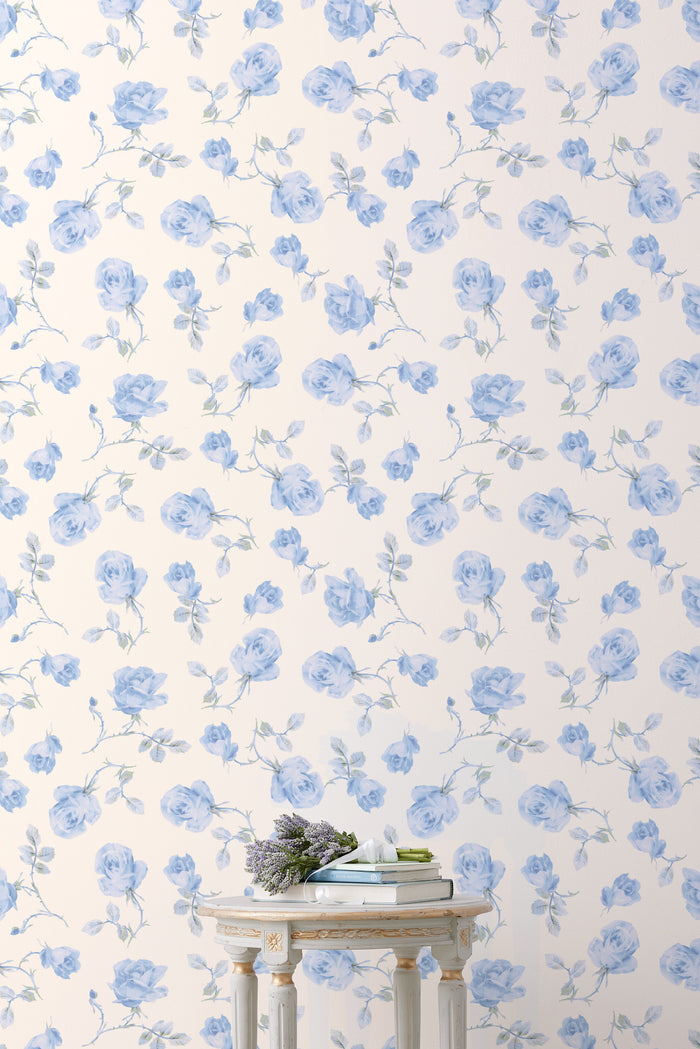 Floral wallpaper roll with light blue rose pattern on cream background