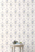 Standard wallpaper roll with repeating blue floral vine pattern on light background