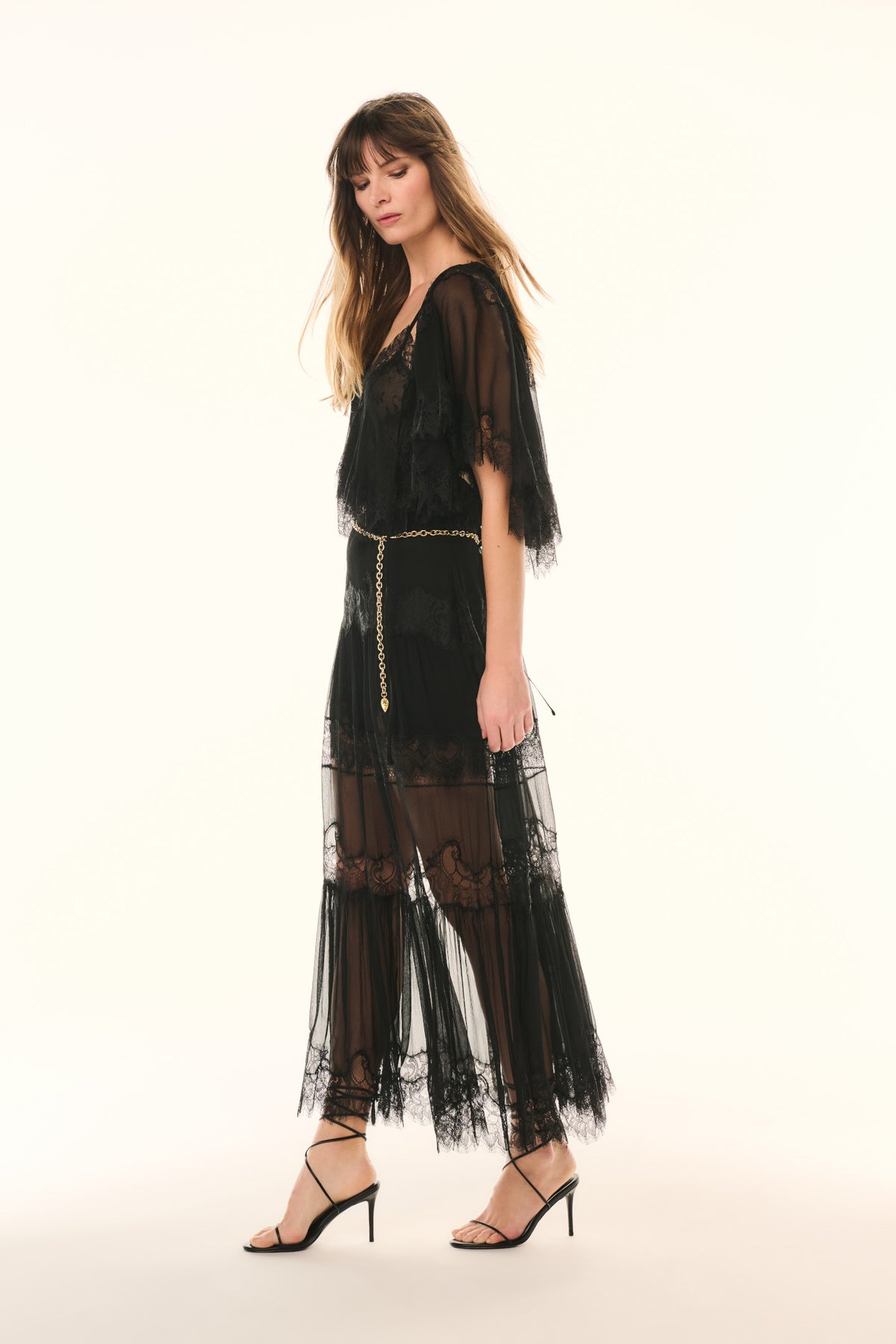 Black lace pleated maxi skirt with sheer tiers, side view and lace-trim hem