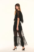 Black lace pleated maxi skirt with sheer tiers, angled profile view