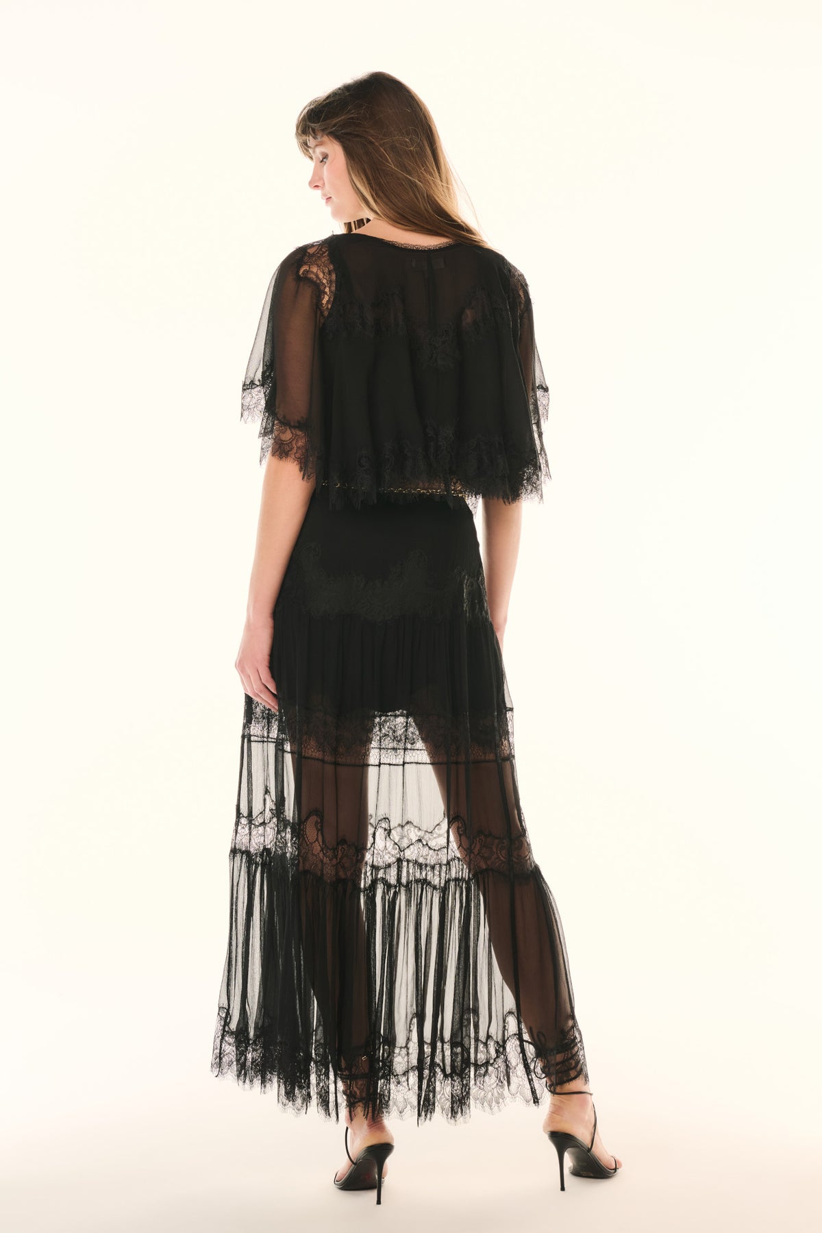 Black lace pleated maxi skirt with sheer tiers, back view with gold chain detail