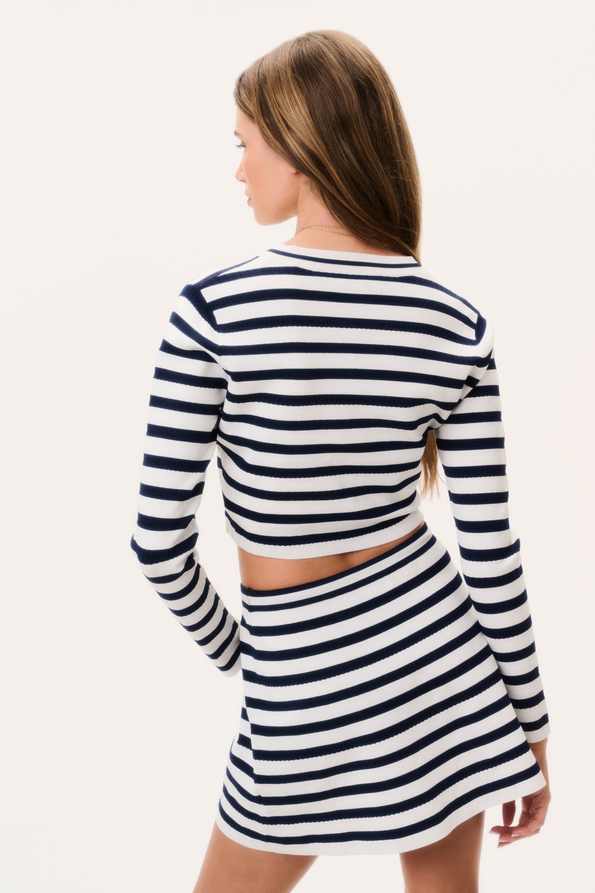 Back view stretch knit mini skirt in navy and white stripes with drawstring waist