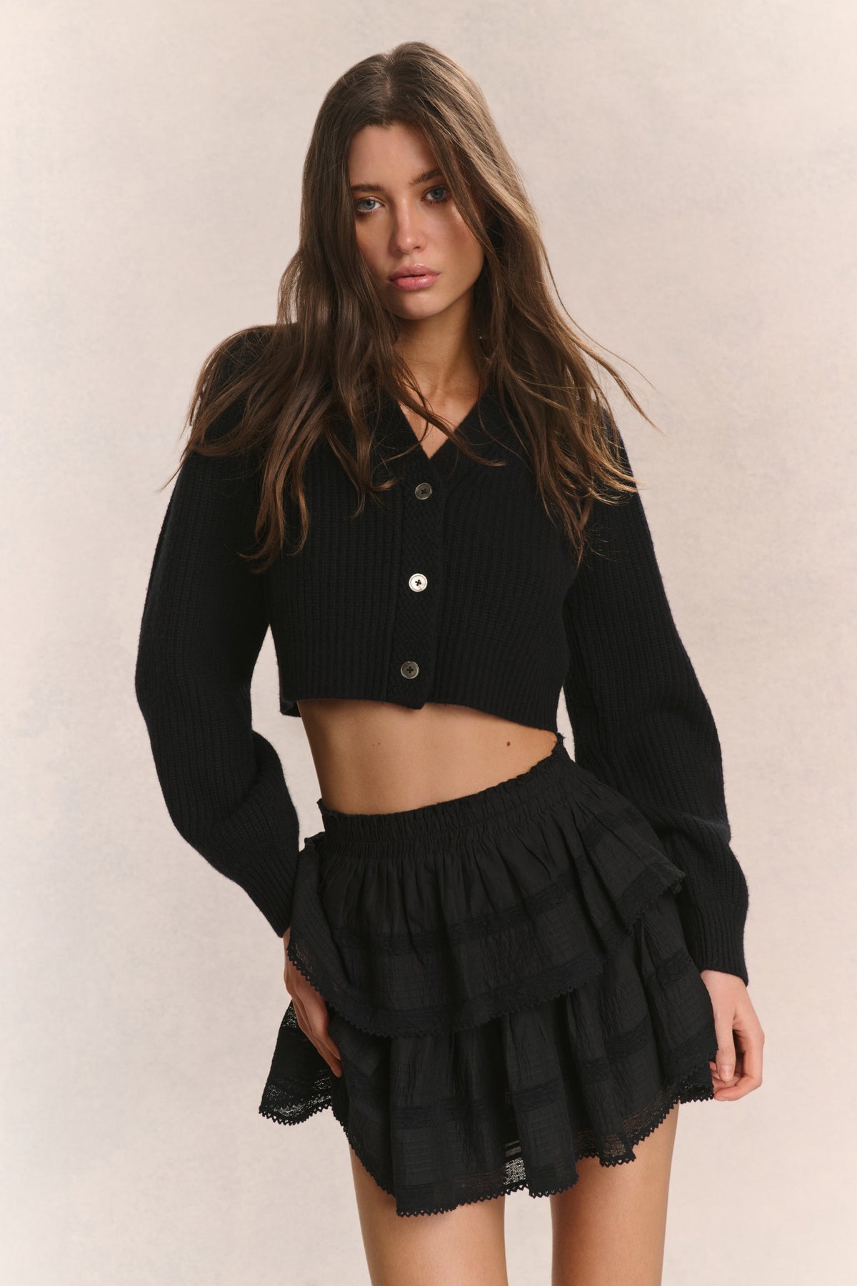 Black ribbed cropped V-neck cardigan with buttons and long sleeves, front view