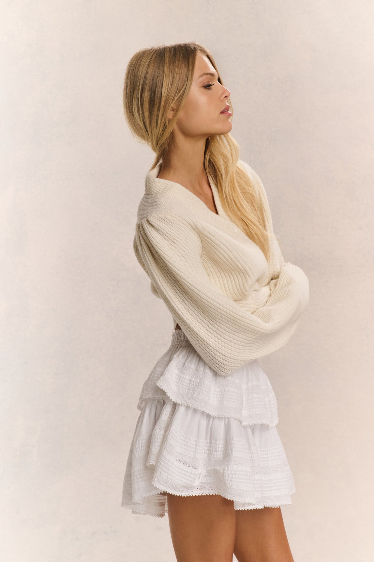 Ivory ribbed V-neck crop cardigan with button front and long sleeves (side view)