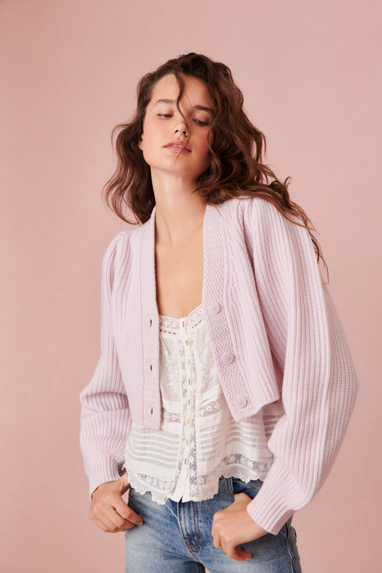 Light pink ribbed cropped V-neck cardigan with button front and long sleeves