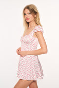 Pink polka-dot mini dress, sweetheart neckline, cap sleeves, ruffled hem