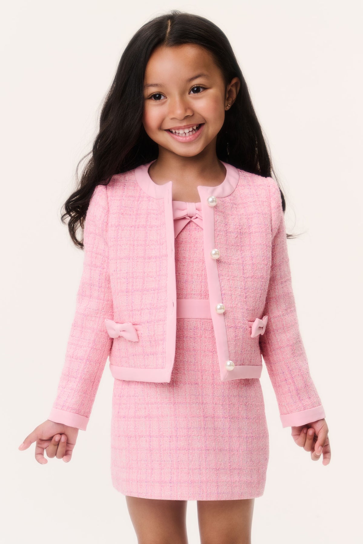 Girls pink tweed cropped jacket with pearl buttons and bow trim, front view