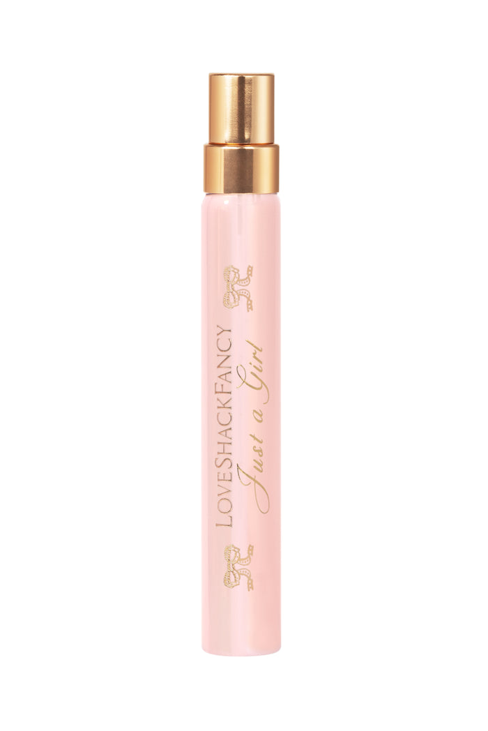 Single pink perfume travel spray bottle with gold mist sprayer, gold-tone top.