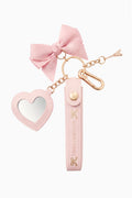 Pink bow keychain with heart charm and small fragrance vial