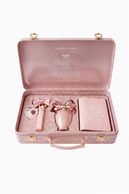Open blush travel fragrance kit case with three matching accessories and ribbon bow