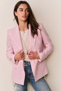 Pink double-breast blazer with bow-tie sleeve detail and long sleeves, worn open