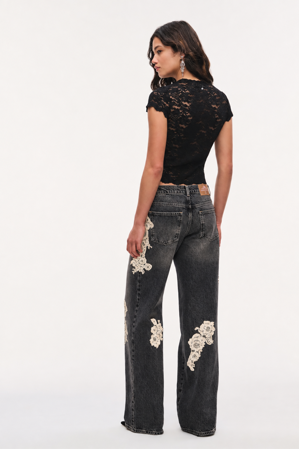 Lace appliqué jeans in dark wash denim, back view with wide legs