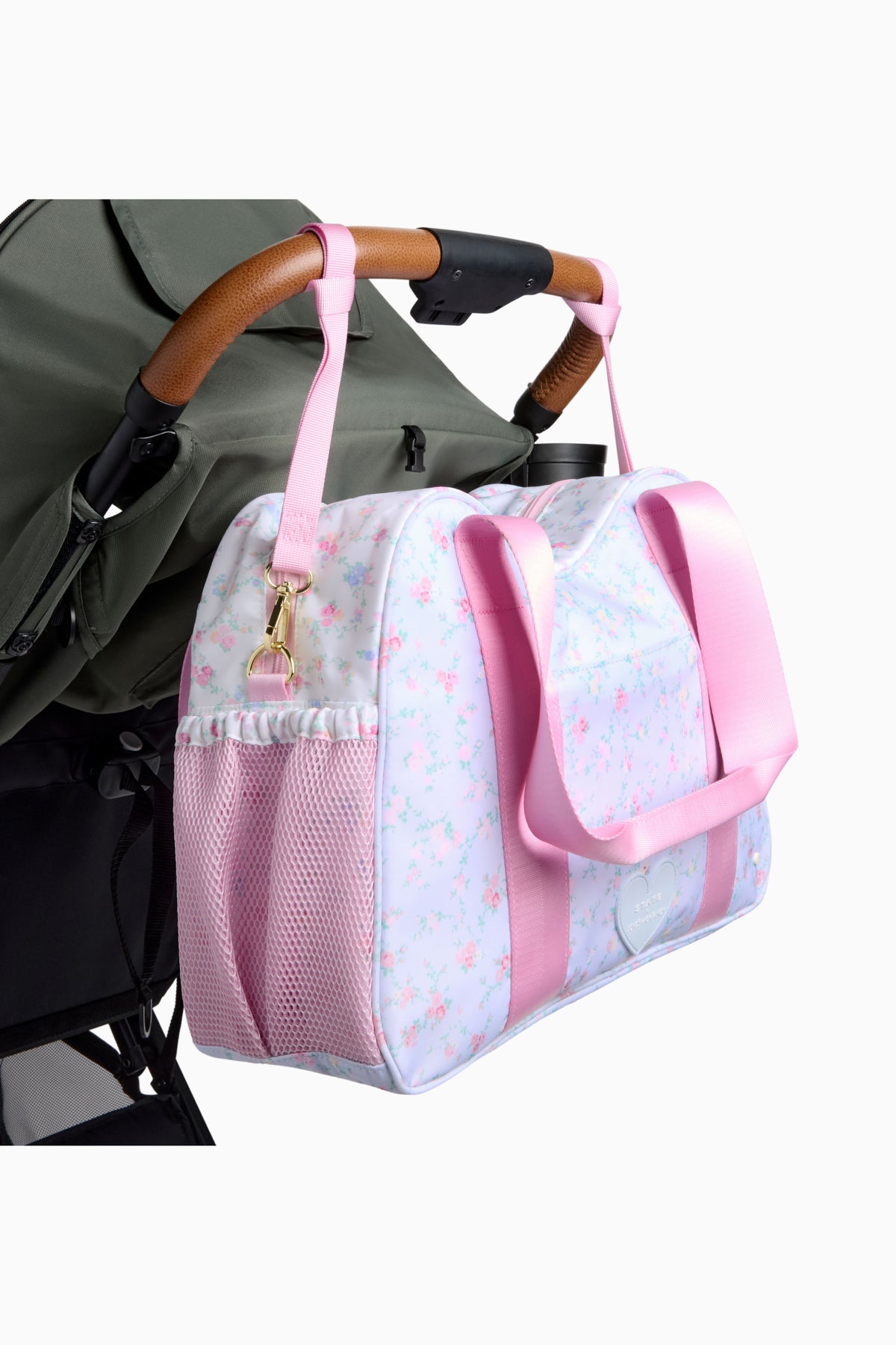 Floral diaper tote with pink strap, mesh pocket, shown on stroller