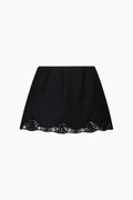 Black slip mini skirt, flat lay with scalloped lace-trim hem