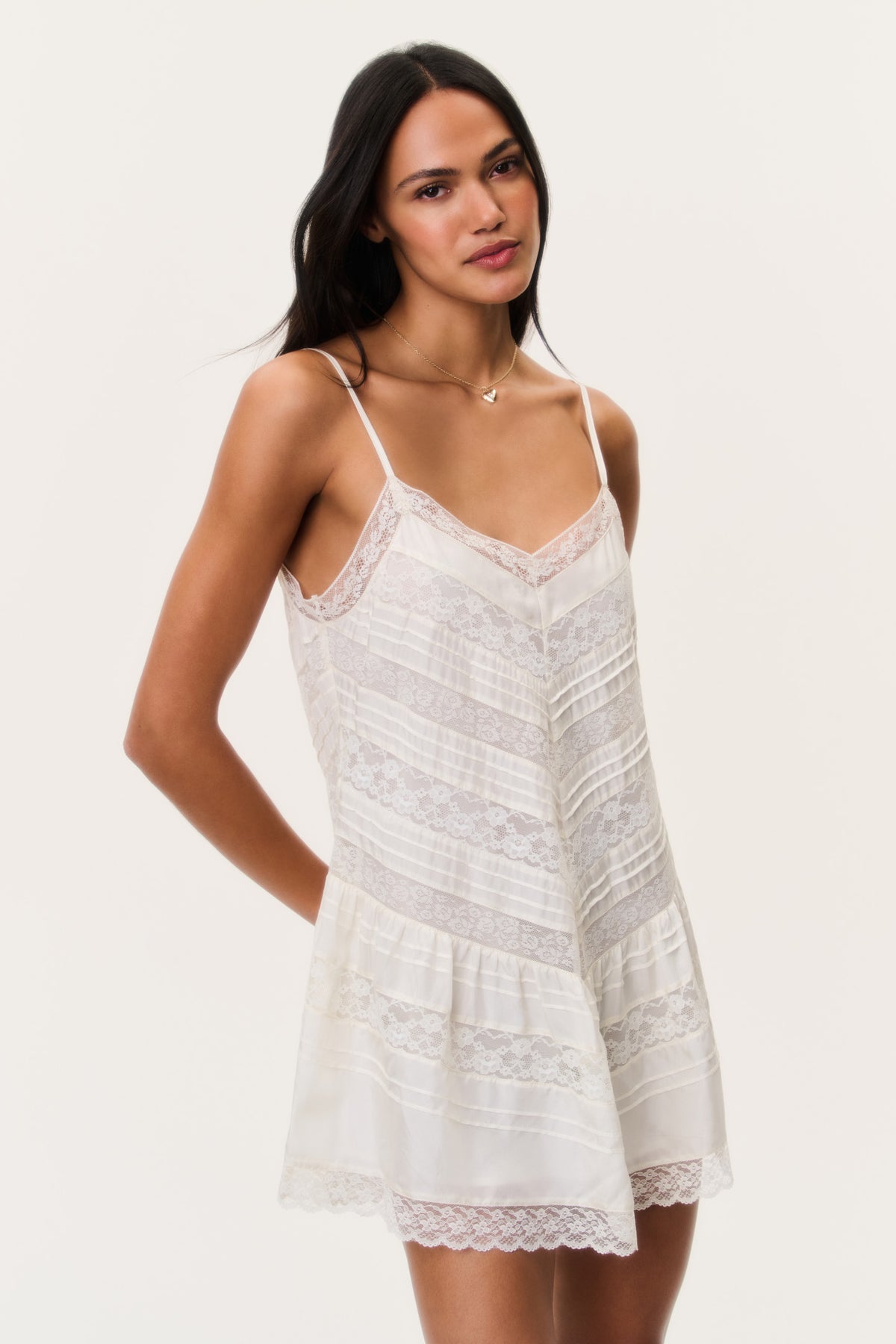 Ivory silk lace mini dress with V-neckline, spaghetti straps, and tiered skirt