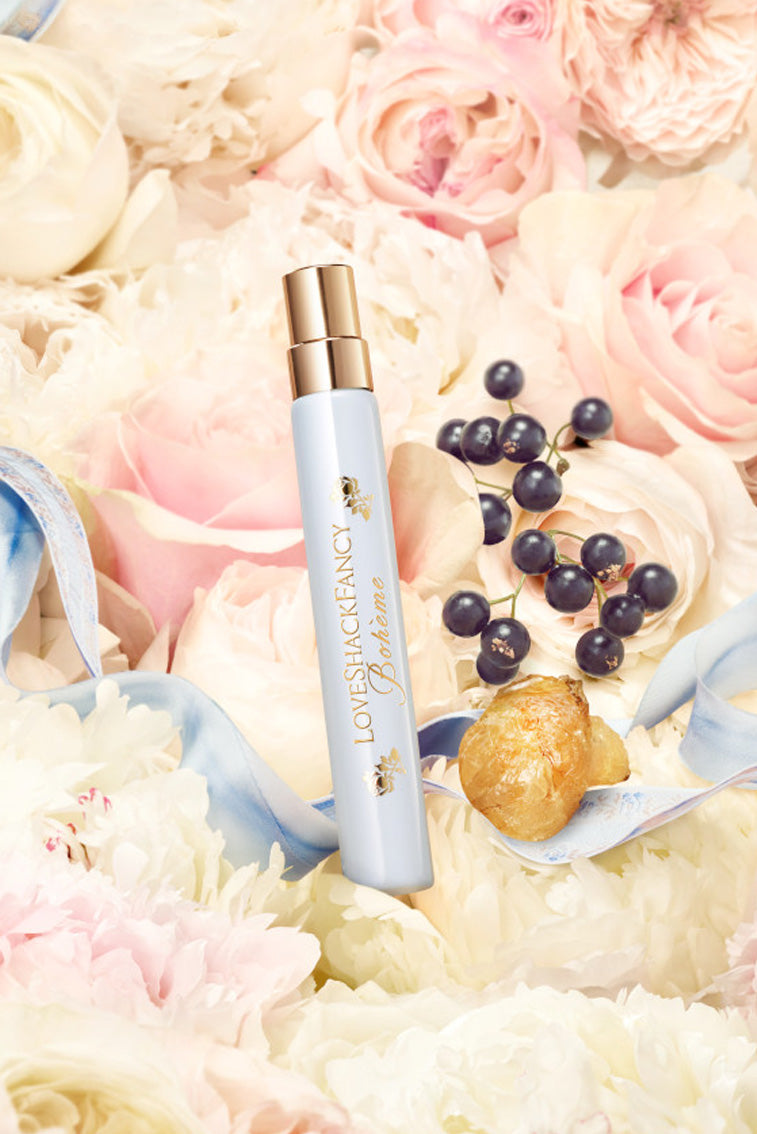 Light blue perfume travel spray bottle with gold cap