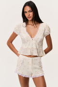 Floral lace-trimmed shorts with scalloped lace trim and elastic waistband.