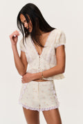 Floral lace-trimmed shorts with scalloped lace trim, side view.