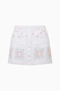 Embroidered cotton mini skirt in optic white, button-front with lace-trim hem