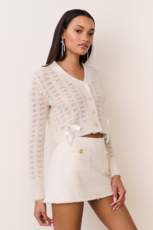 Cream tweed mini skirt with gold button detail and frayed textured edge