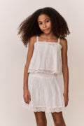 White cotton tiered skirt with elastic waist and lace-trimmed scalloped hem