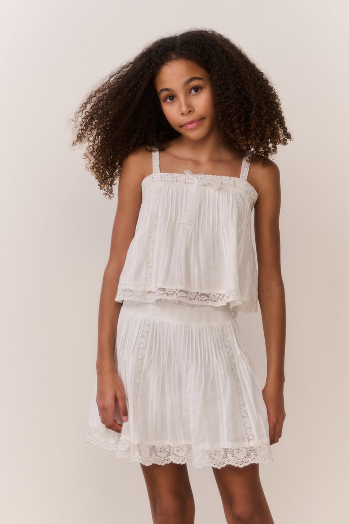 White cotton tiered skirt with elastic waist and lace-trimmed scalloped hem