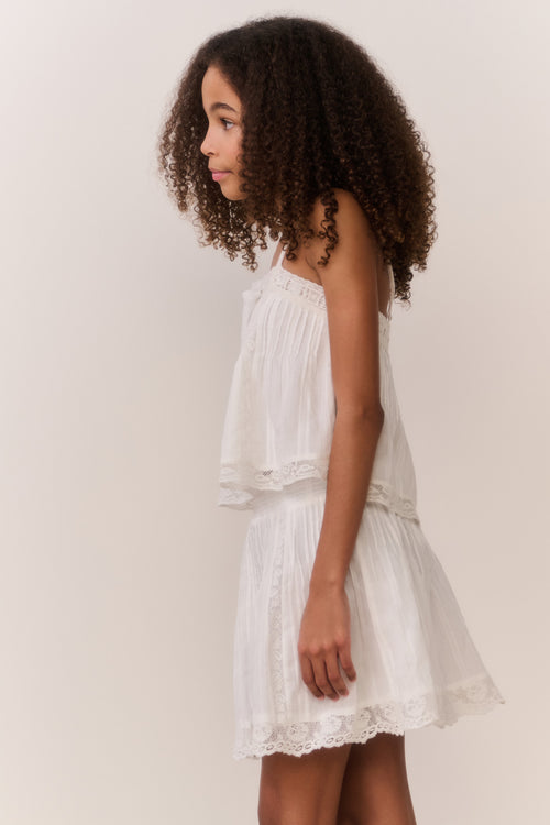 White cotton tween sleeveless top with spaghetti straps and tiered ruffle hem