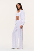 Optic white eyelet linen pants, drapey wide-leg silhouette with scattered tiny embroidered dots