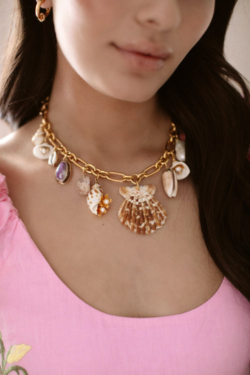 Gold beach-bound necklace with seashell and pearl charms, link chain