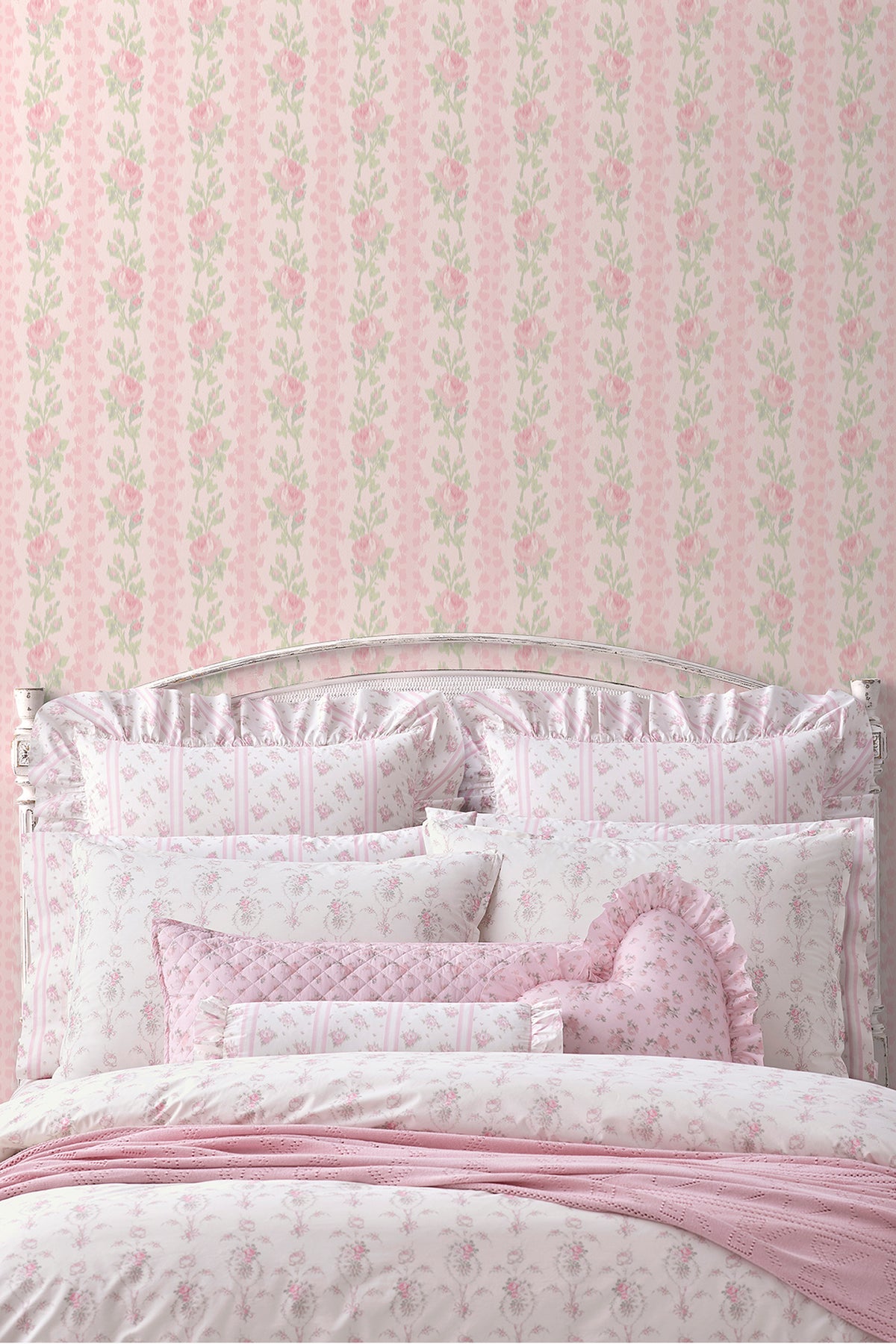 Peel-and-stick wallpaper backdrop with pink rose and green leaf pattern