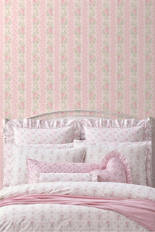 Peel-and-stick wallpaper backdrop with pink rose and green leaf pattern