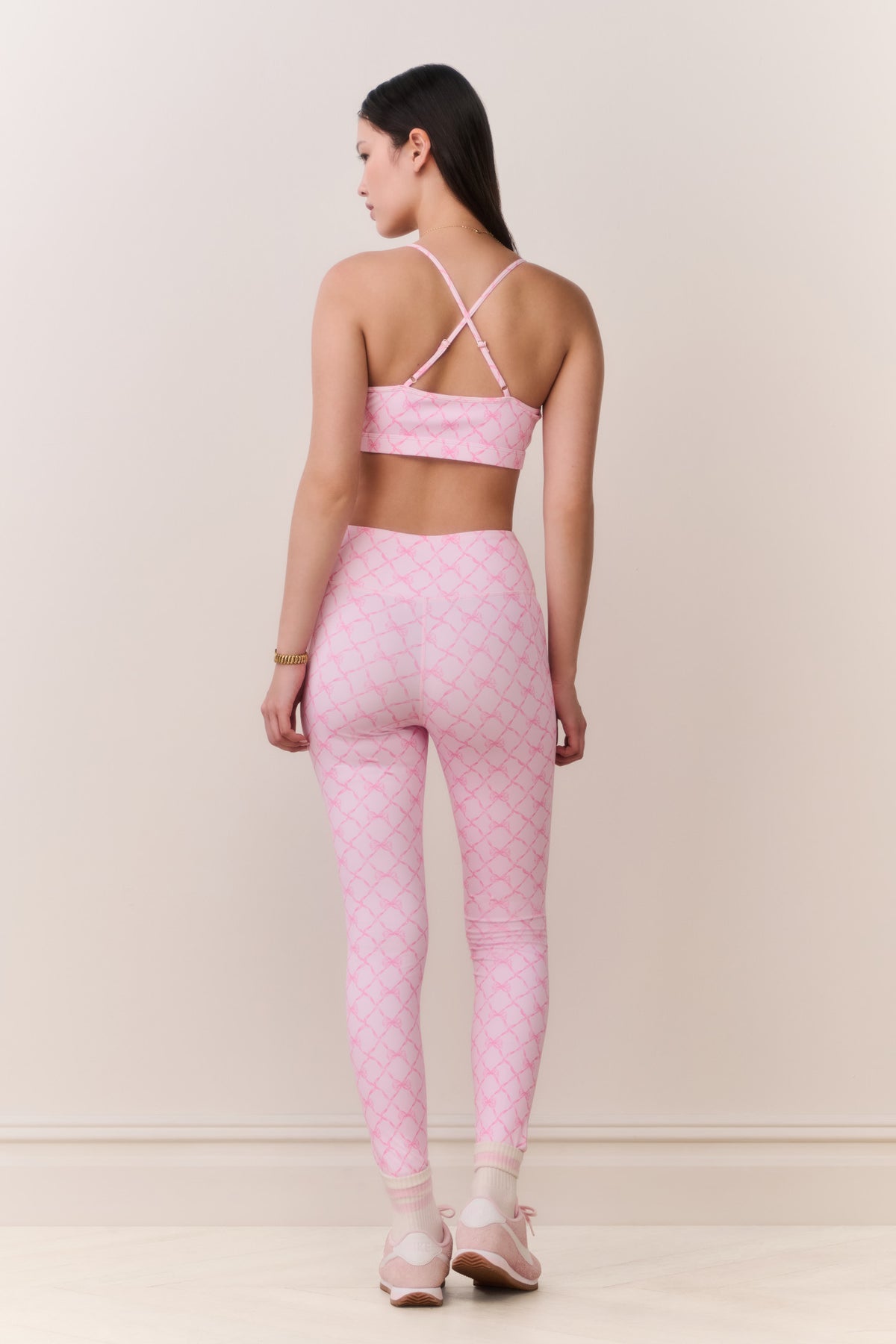 Pink sports bra with thin straps and geometric lattice pattern