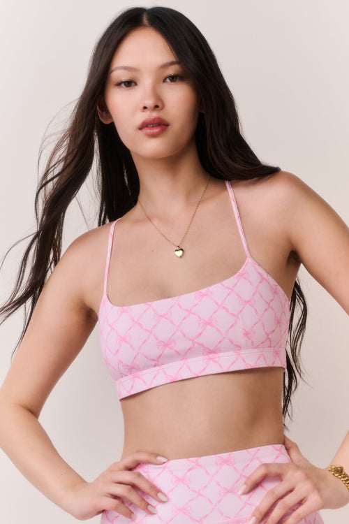 Pink sweetheart sports bra with thin straps and geometric lattice print